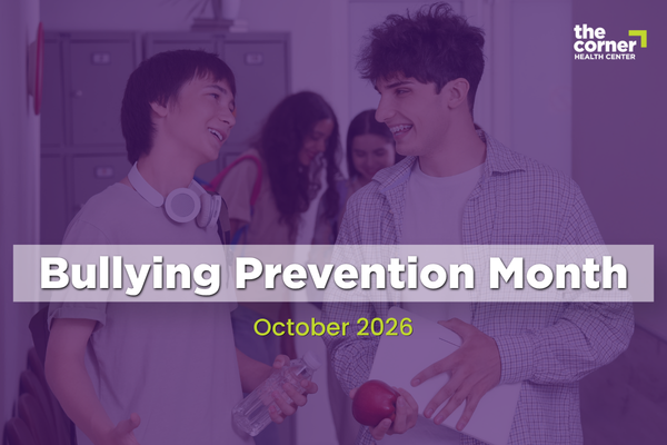 Promotional graphic for Bullying Prevention Month. Two students stand in a school hallway talking while holding school supplies, with other students and lockers visible in the background. A purple overlay covers the image. Large text reads “Bullying Prevention Month” and smaller text below reads “October 2026.” The Corner Health Center logo appears in the upper-right corner.